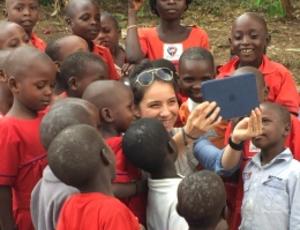 Military engineer takes picture of herself with group of Ugandan kids.