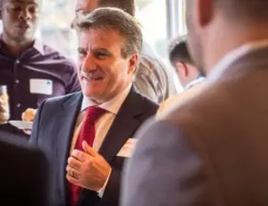 Veolia North America CEO Bill DiCroce in suit and red tie.