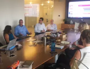 Seven Veolia employees posing in conference room after Crowdsourcing Challenge.