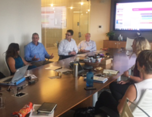 Seven Veolia employees posing in conference room after Crowdsourcing Challenge.