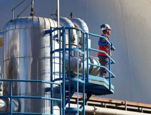 A Veolia employee stands in an anaerobic digestion facility