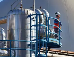 A Veolia employee stands in an anaerobic digestion facility